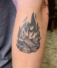 A black and white tattoo of a campfire illustration