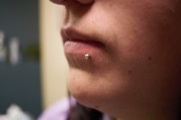 A woman with a side labret lip piercing