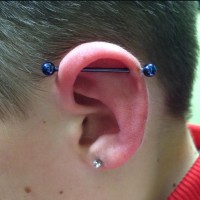 A blue bar industrial ear piercing