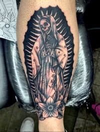 A tattoo of a skeleton in a robe