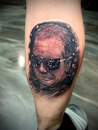 A photorealistic black and white tattoo of a Dale Earnhardt