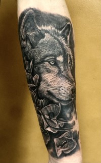a black ink tattoo of a husky head and flowers