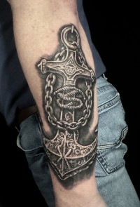 a black ink tattoo of an anchor and chains