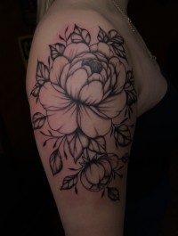 illustrative tattoo of a flower on the shoulder