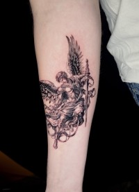 black and grey Icarus tattoo on the forearm