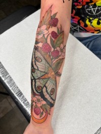 color tattoo of a moth in flowers