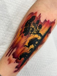 color tattoo of an elephant in the sunset