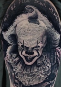 Black and white tattoo of Pennywise from Stephen King's "It."