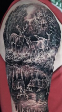 Black and white tattoo of a family of deer by the water