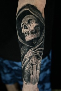 a black ink tattoo of a skeleton wearing a dark hood