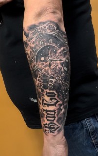 a black ink tattoo of a celestial clock