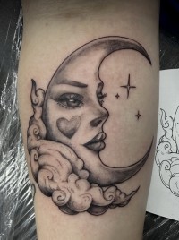 a tattoo of a crescent moon with a woman's face