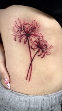a red ink tattoo of flowers