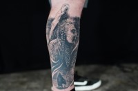 black and grey tattoo on the leg
