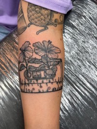 Tattoo of a drawing of a cassette tape with flowers