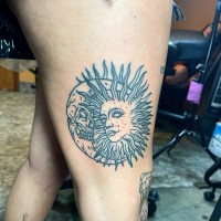 Tattoo of a drawing of the sun and moon with faces