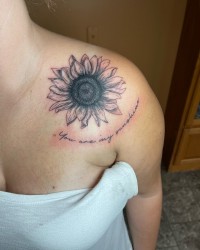 Tattoo of a sunflower captioned, "You are my sunshine"