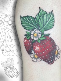 A color tattoo of strawberries and blossoms