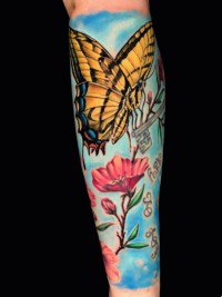 color tattoo of a butterfly on a red flower