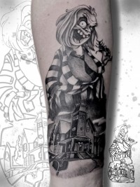 A black and white tattoo of the cartoon Beetlejuice character and haunted mansion