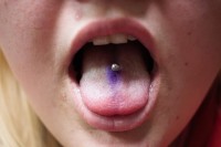 A woman with a tongue piercing